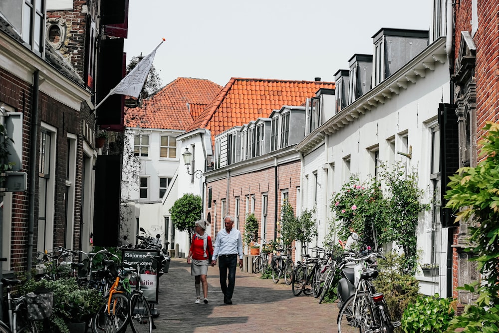 couple holding between buildings