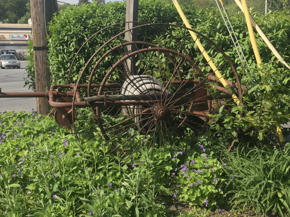 brown metal wheel on plants