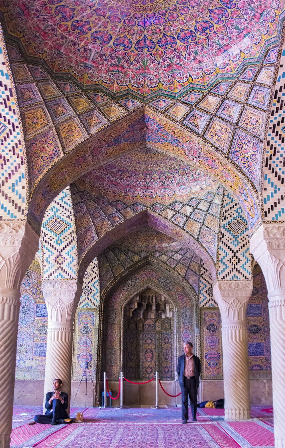 two men in arch hallway