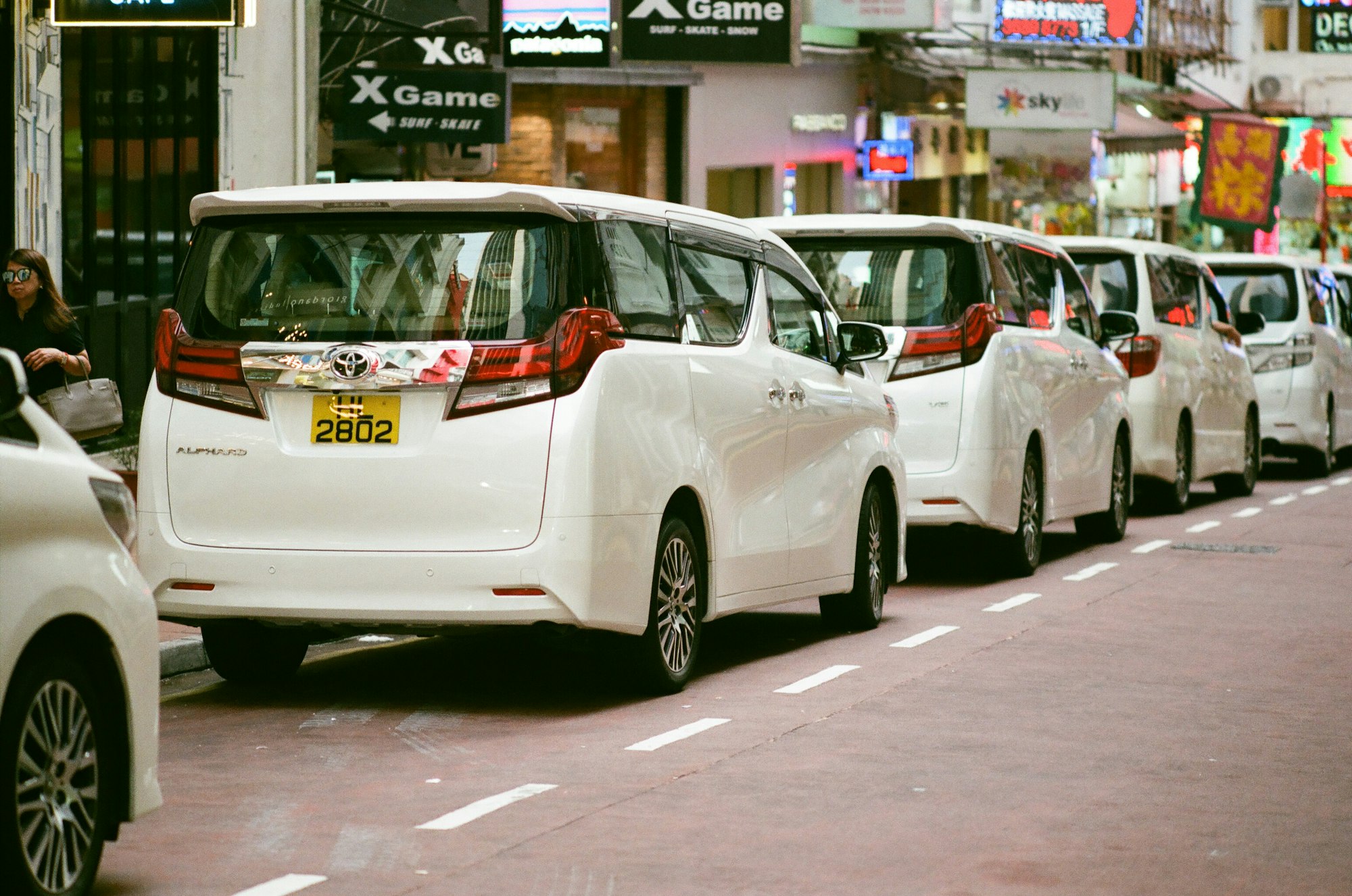 four white Toyota station wagons lined on road