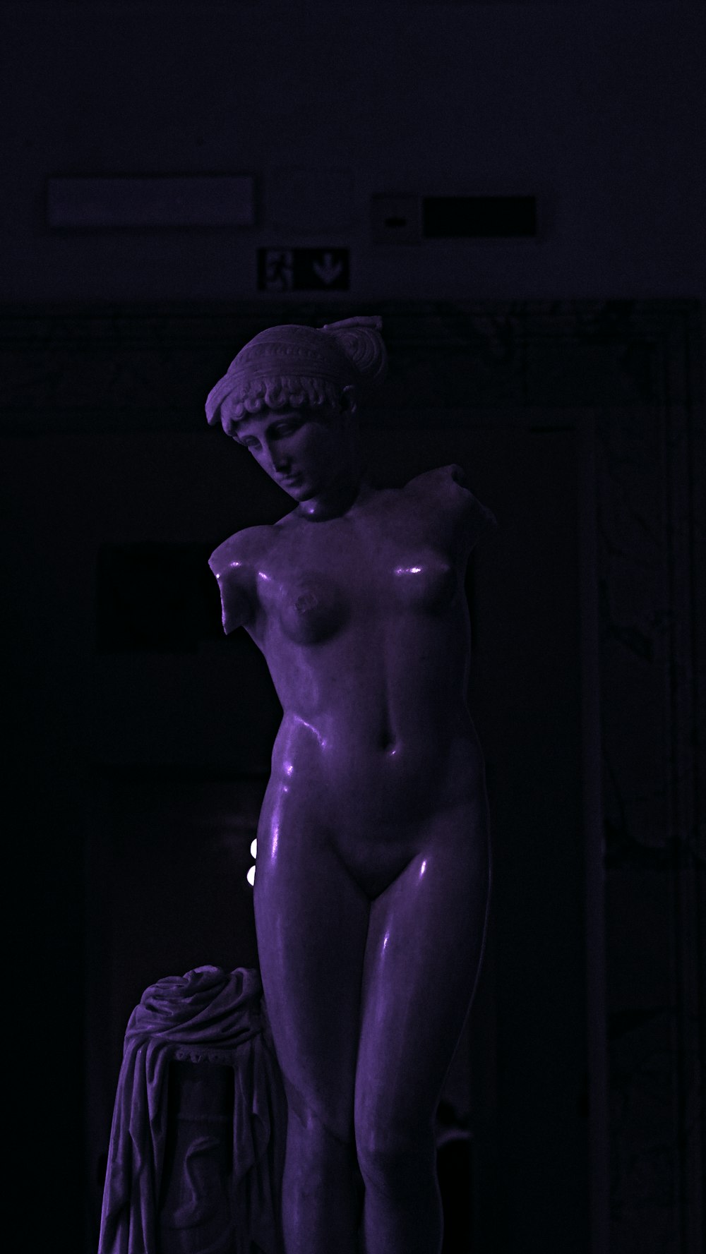 a statue of a woman in a dark room