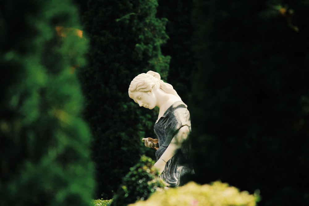 selective focus photography of woman statue