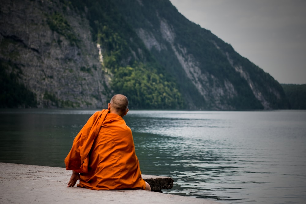 man sitting near ocean