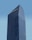 A modern skyscraper with a glass facade and the logo of BNP Paribas displayed prominently at the top against a clear blue sky. The building is characterized by its rectangular shape with vertical lines, creating a sleek and professional appearance.