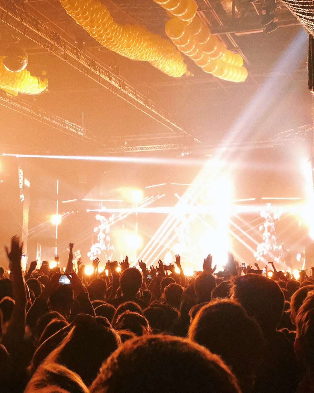 people standing toward stage with lights