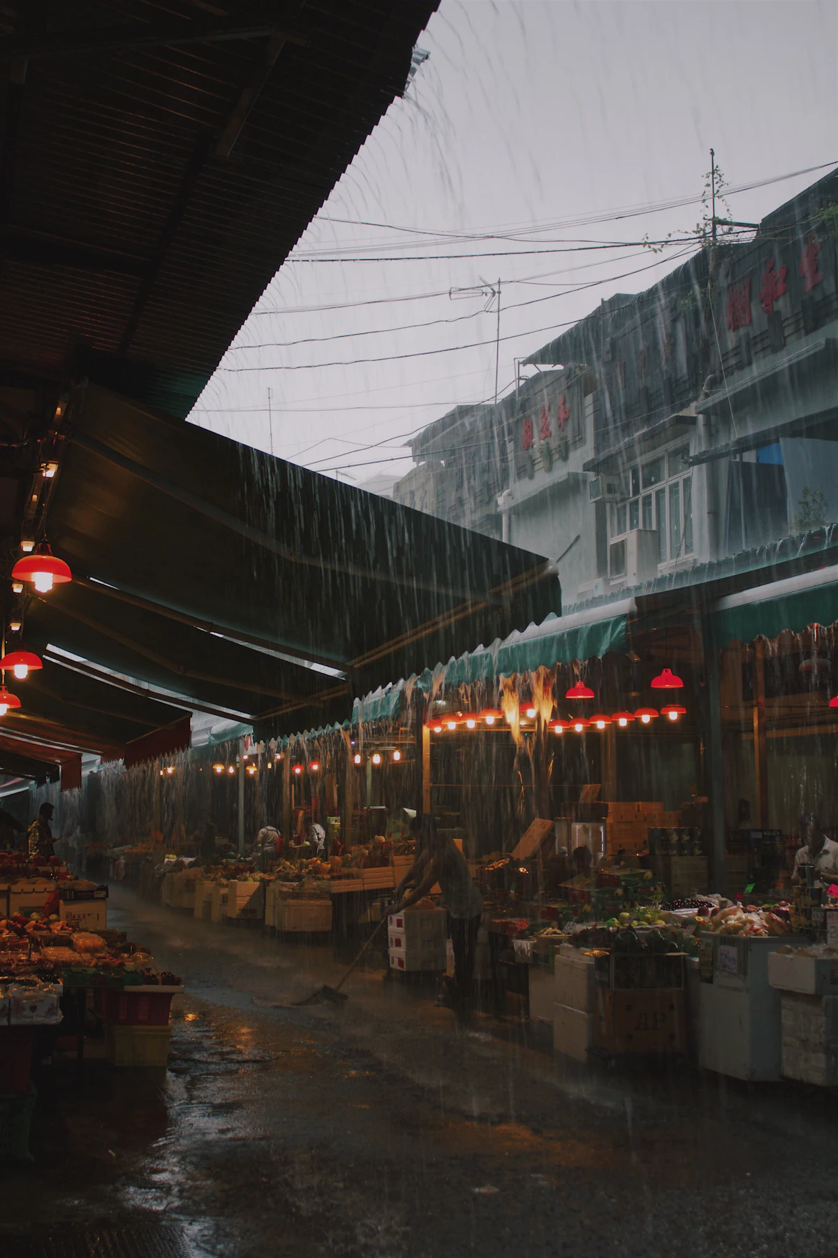 Market stalls under awnings on a rainy day