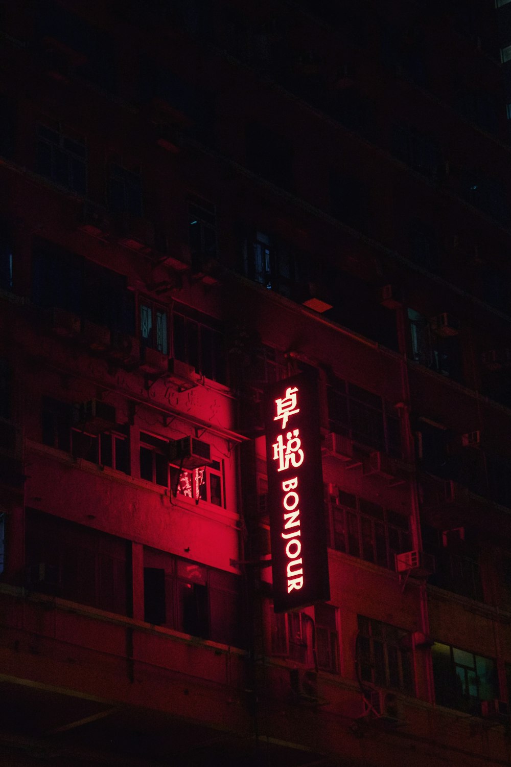 Bonjour LED sign near buildings