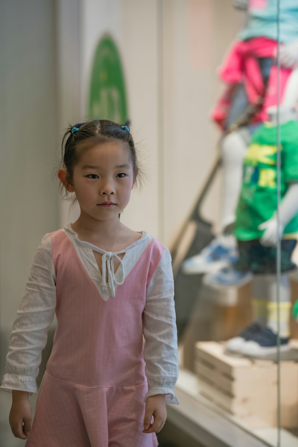 girl walking beside glass wall