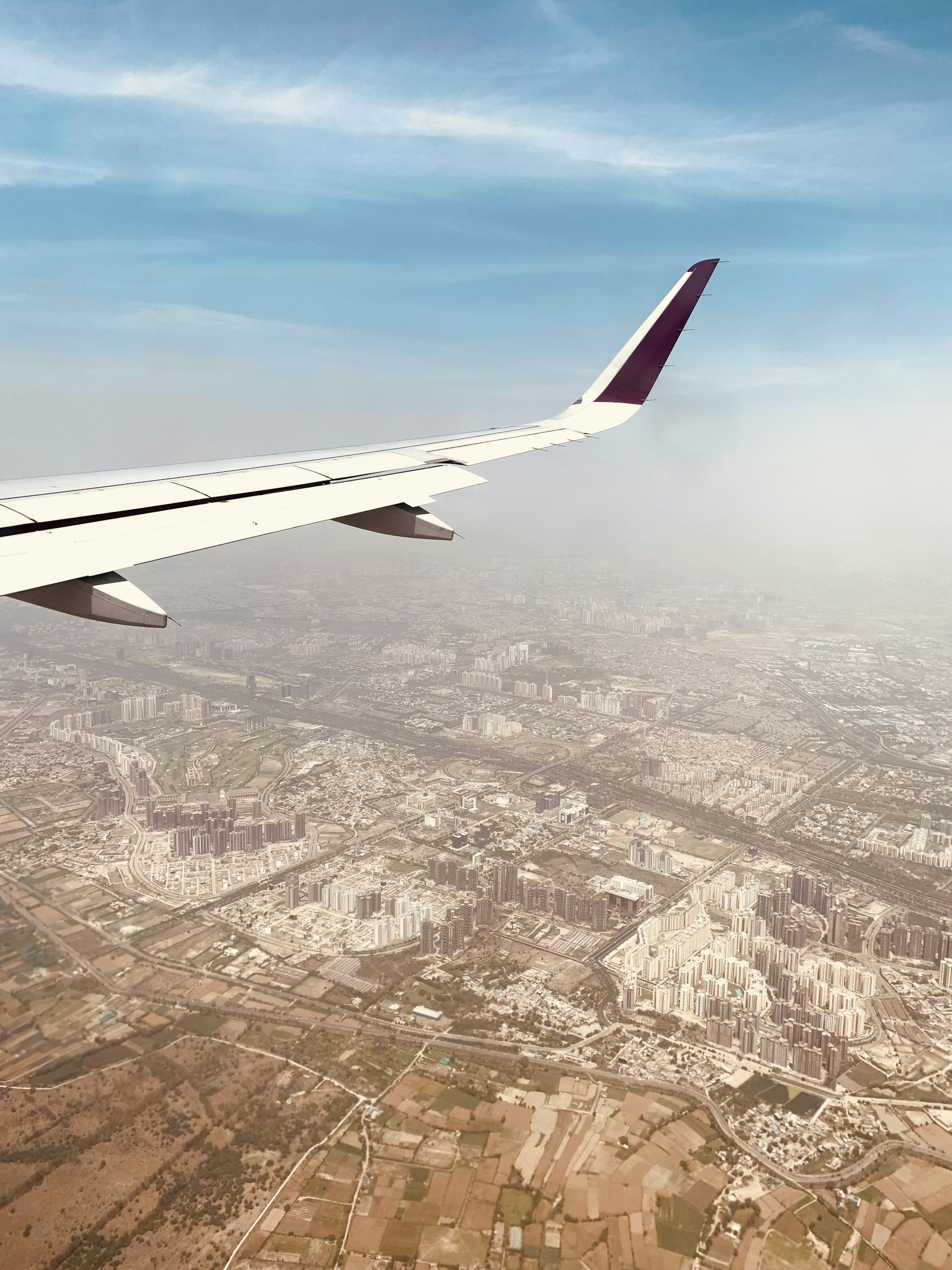 woman wearing yellow long-sleeved dress under white clouds and blue sky during daytime