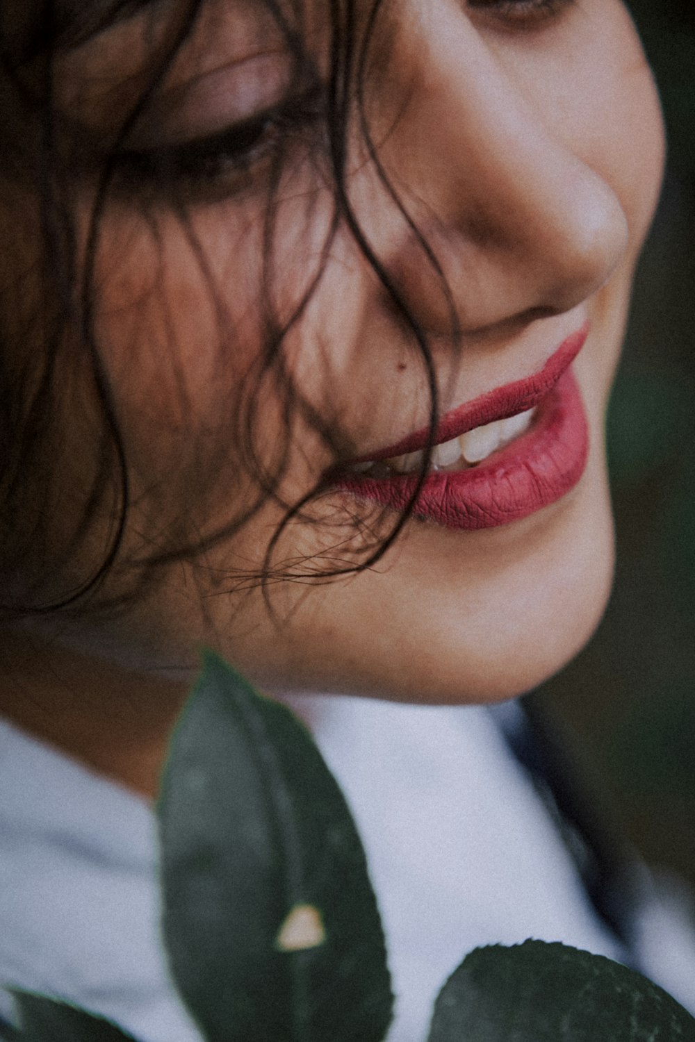 a close up of a woman with a flower in her hair