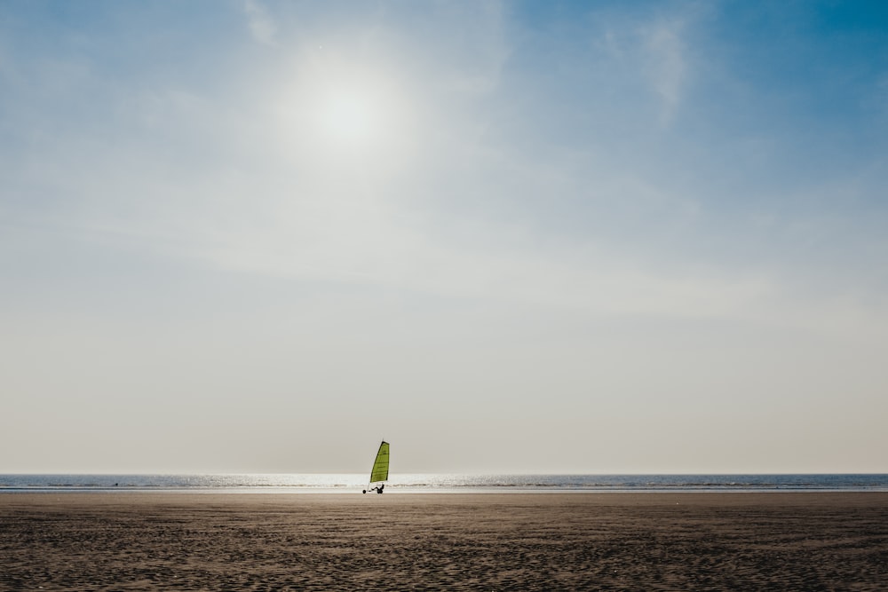 green sailboat on sea during daytime
