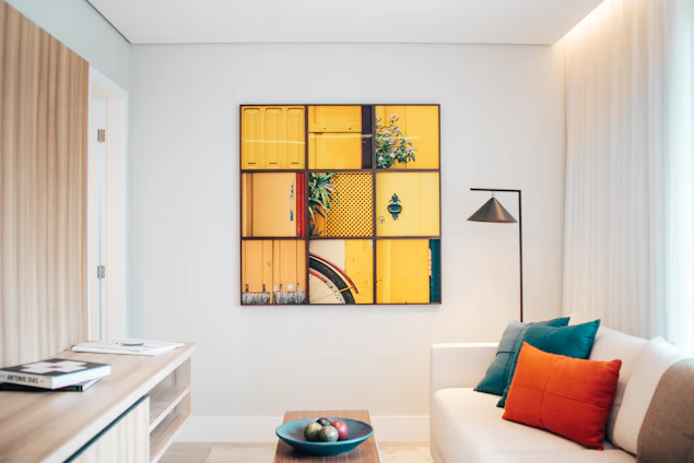 A cozy modern living room featuring a large, colorful personalized art piece on the wall.