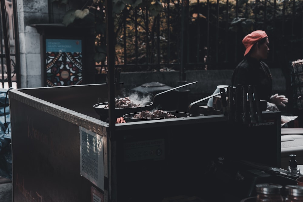 person standing near cooking section