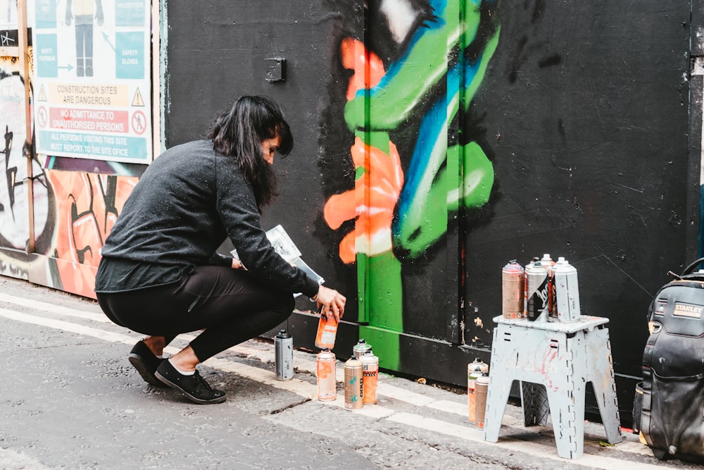 woman making wall mural