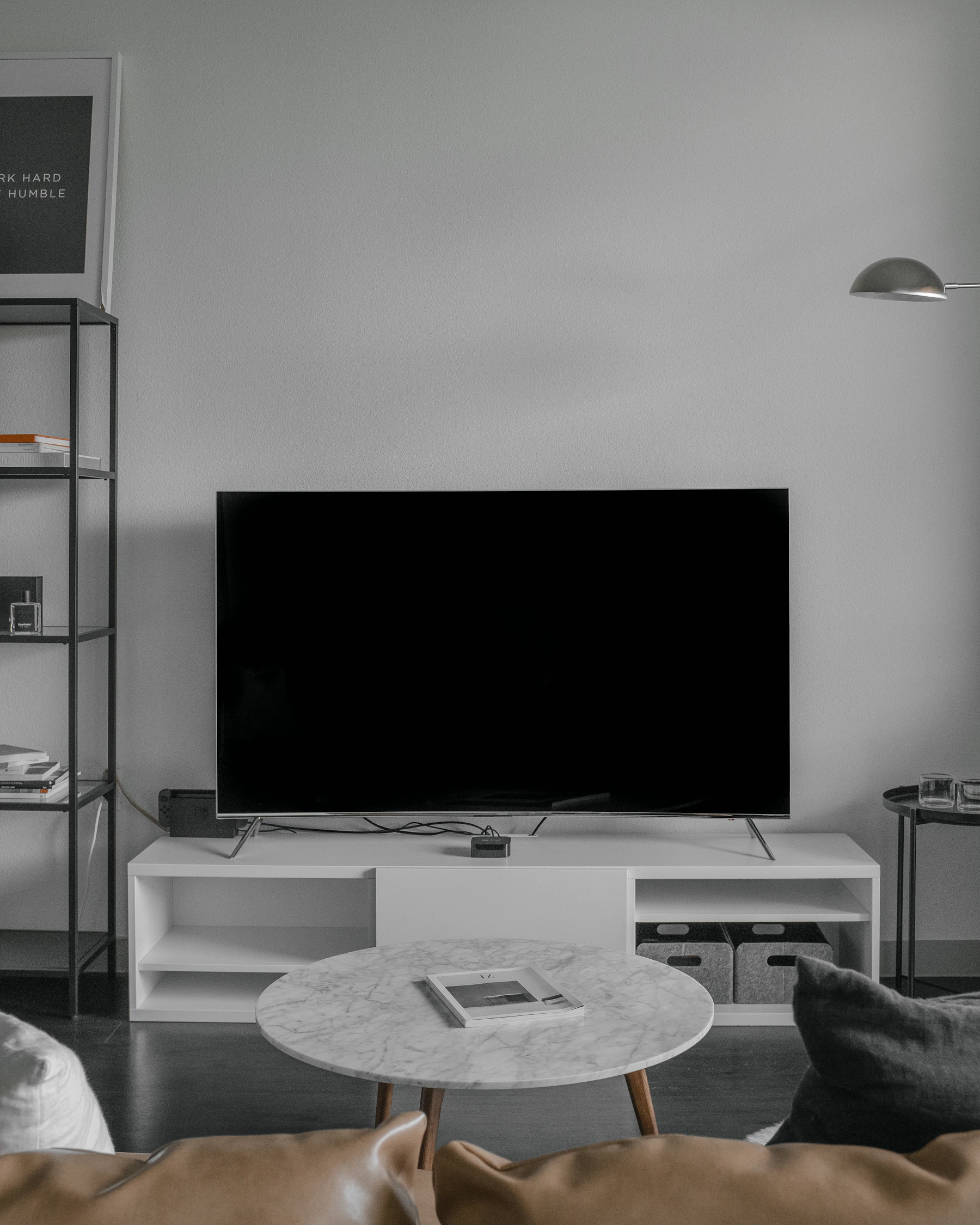 Large home projection screen glowing in a dark minimal cinema room