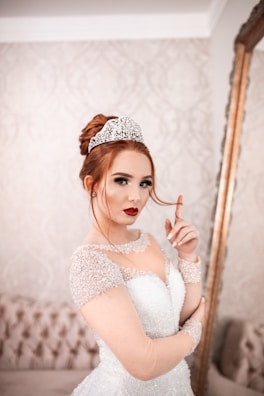 Elegant bridal makeup featuring creamy tones with a striking red blush highlight.