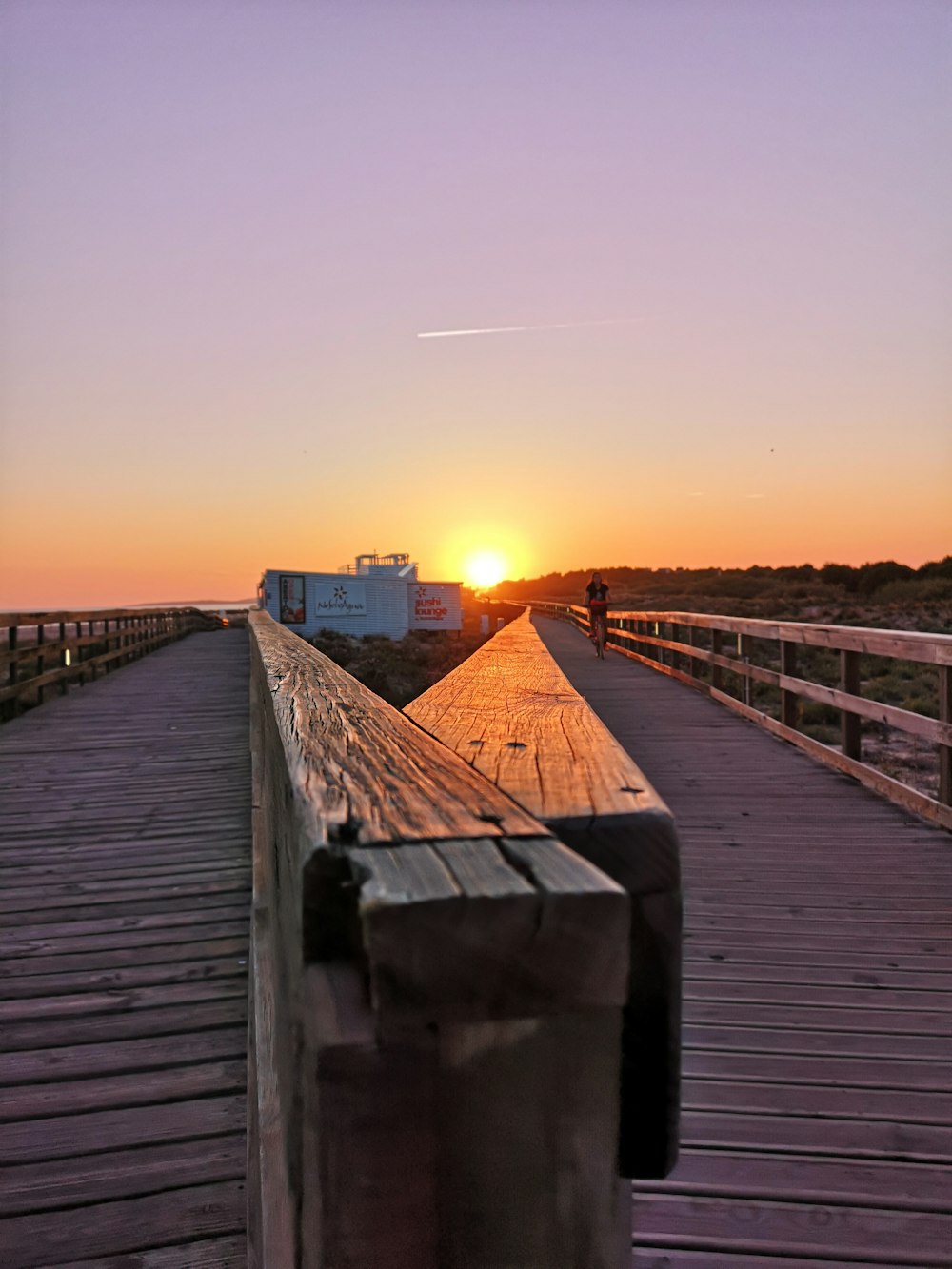 brown wooden pathway during sunrise