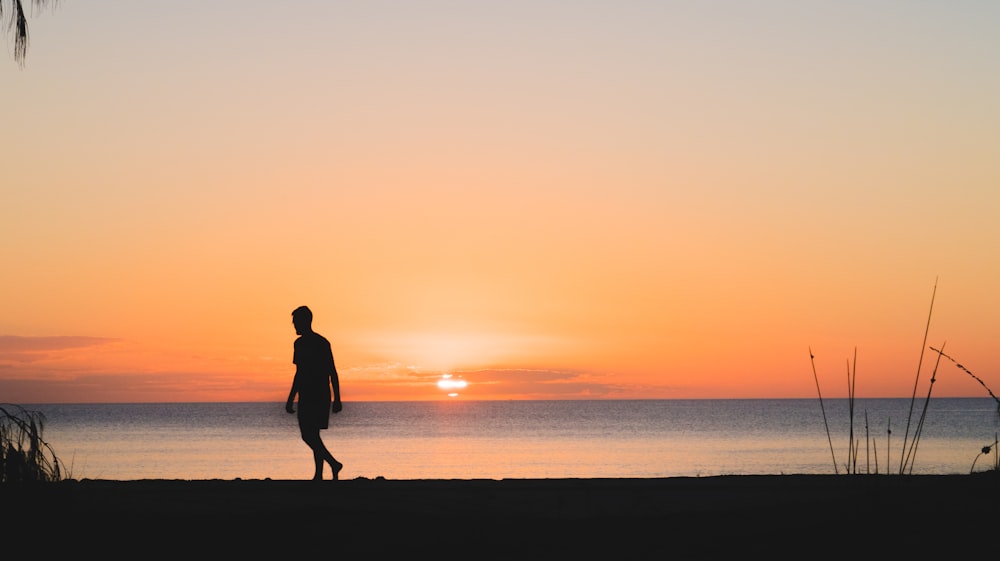 man walking near ocean