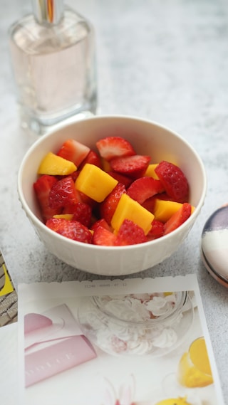 sliced strawberries on white bow