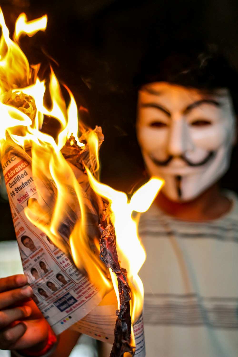 person holding flamed paper