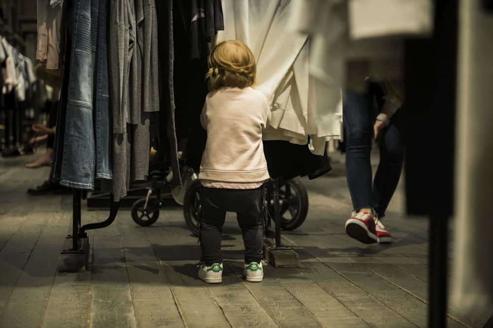 girl standing near clothes