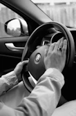 person holding steering wheel