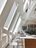 Minimalist tasting room with natural light highlighting wine and olive oil displays.
