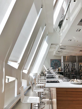 Minimalist tasting room bathed in natural light with elegant wine glasses.