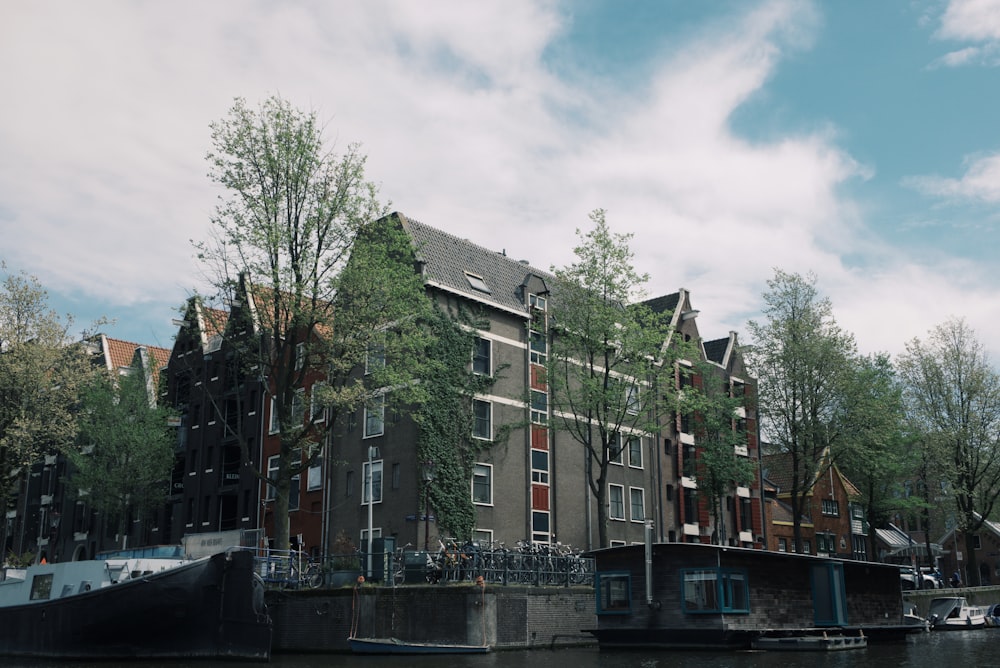 grey building in river bank