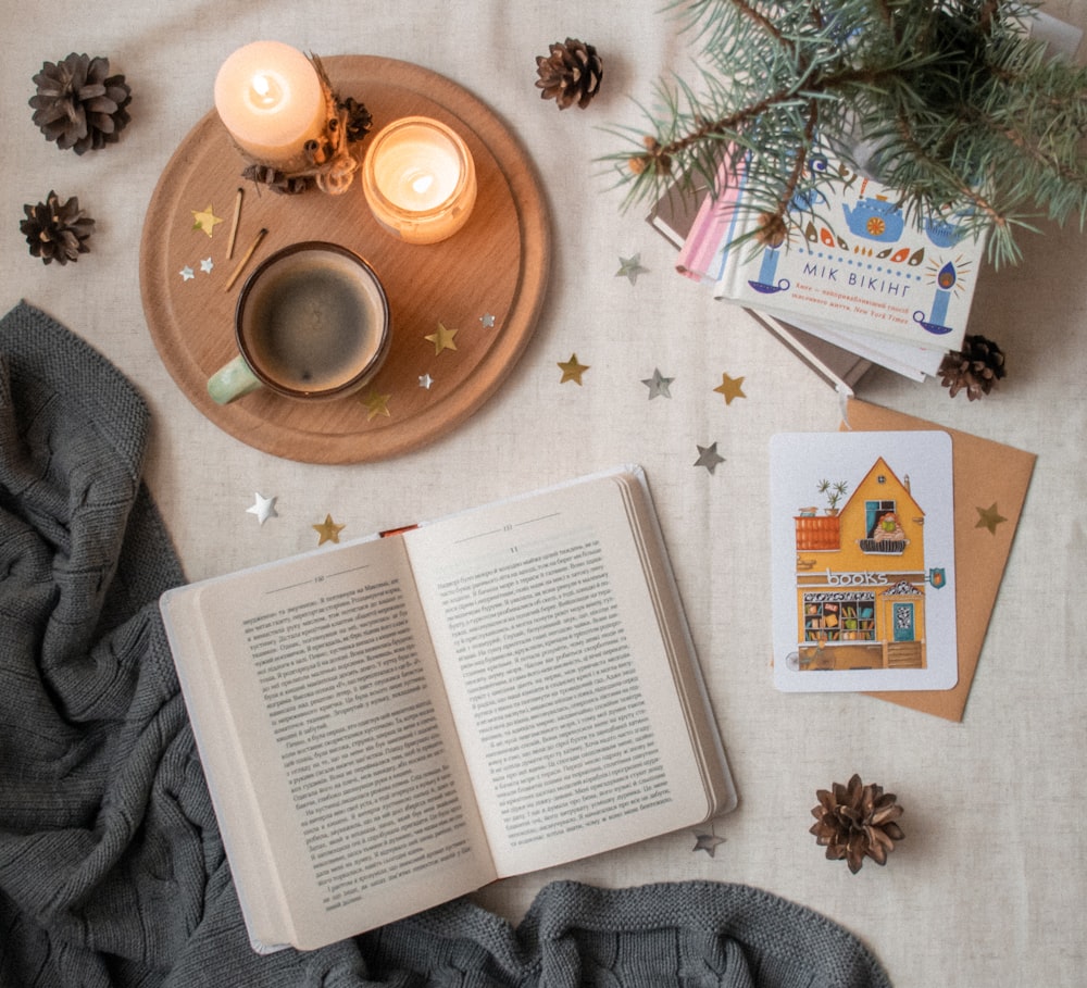 white opened book beside tray