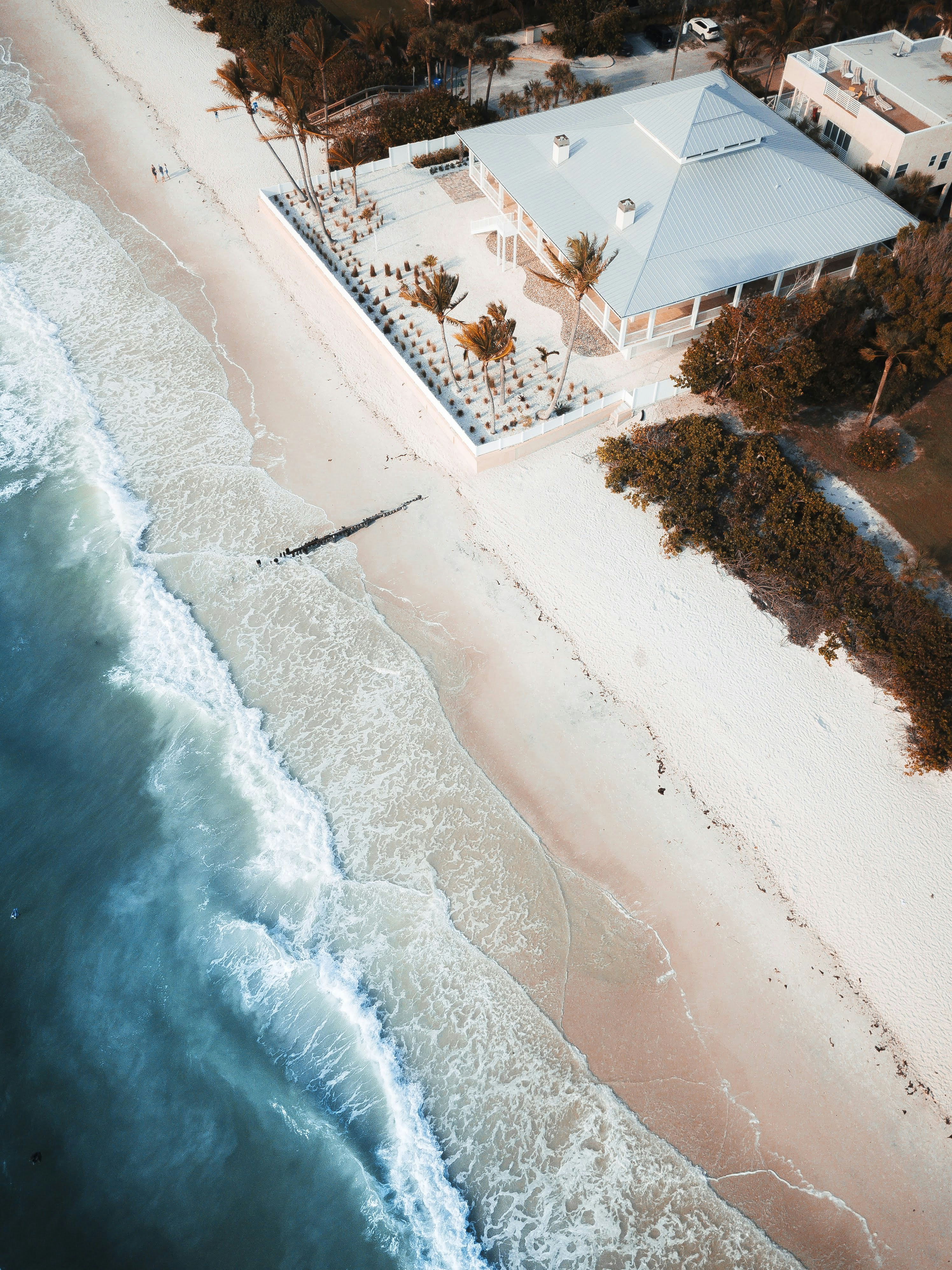 aerial photo of gray house near beach