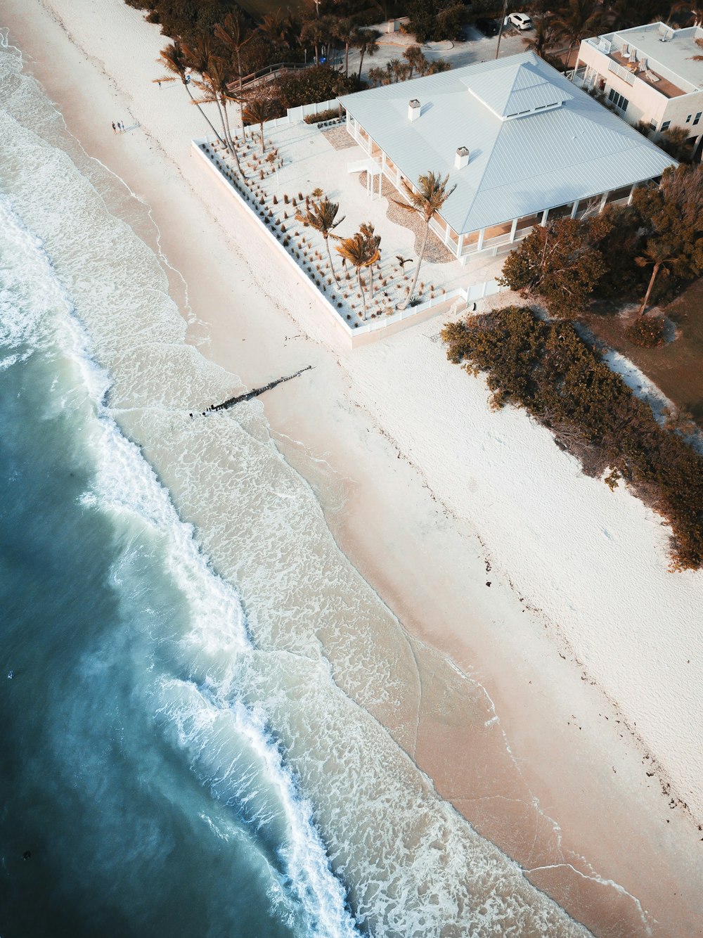 aerial photo of gray house near beach