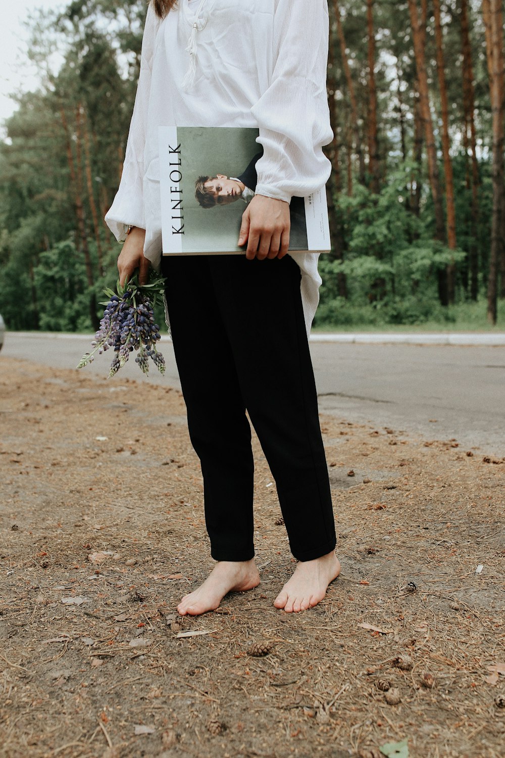 woman carrying white hardbound book