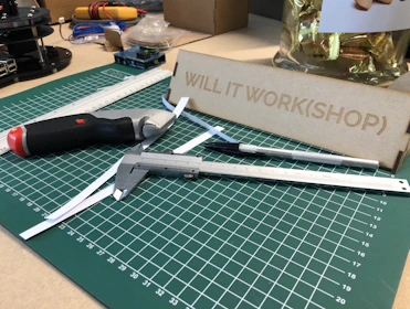 Close-up of a worker measuring and cutting plastic sheeting with precision tools.