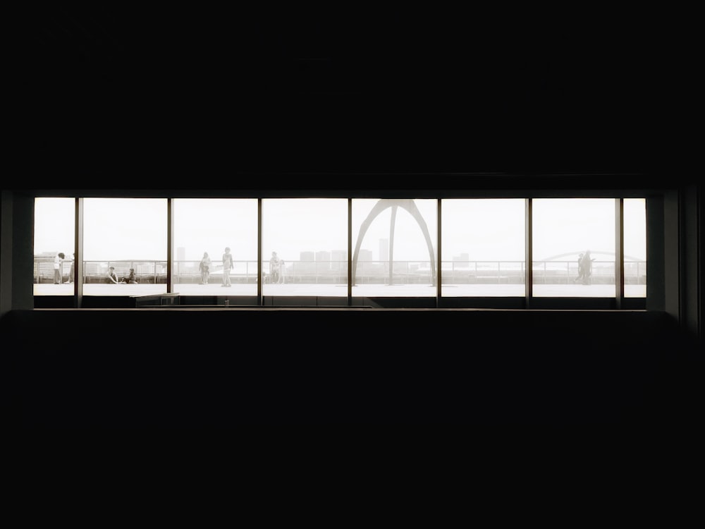 a window in a dark room with a view of a bridge
