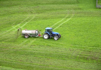 brown tractor on green grass field