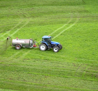 brown tractor on green grass field