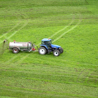 brown tractor on green grass field