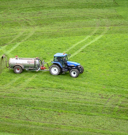 brown tractor on green grass field