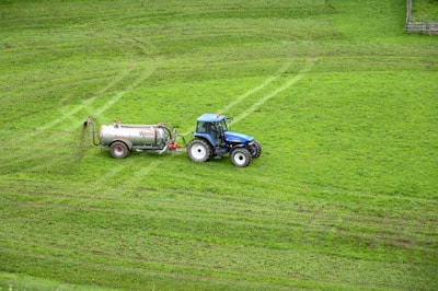brown tractor on green grass field