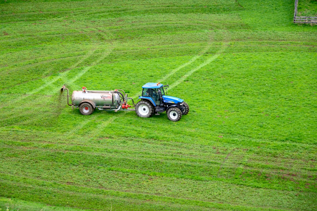 pandanus fertilizer, fertilizer, brown tractor on green grass field