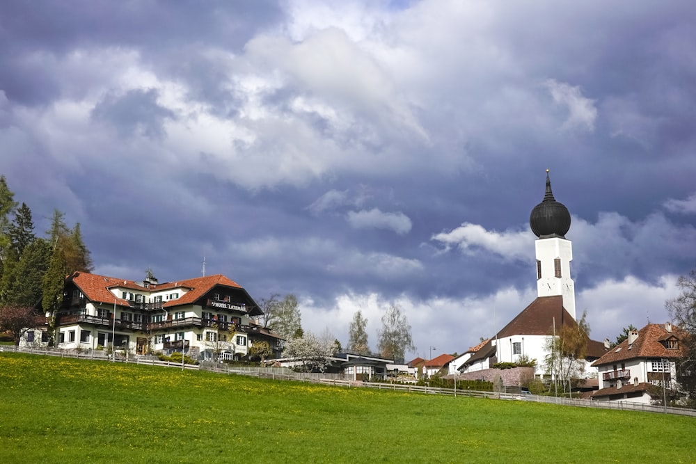 a church on a hill with a cloudy sky in the background