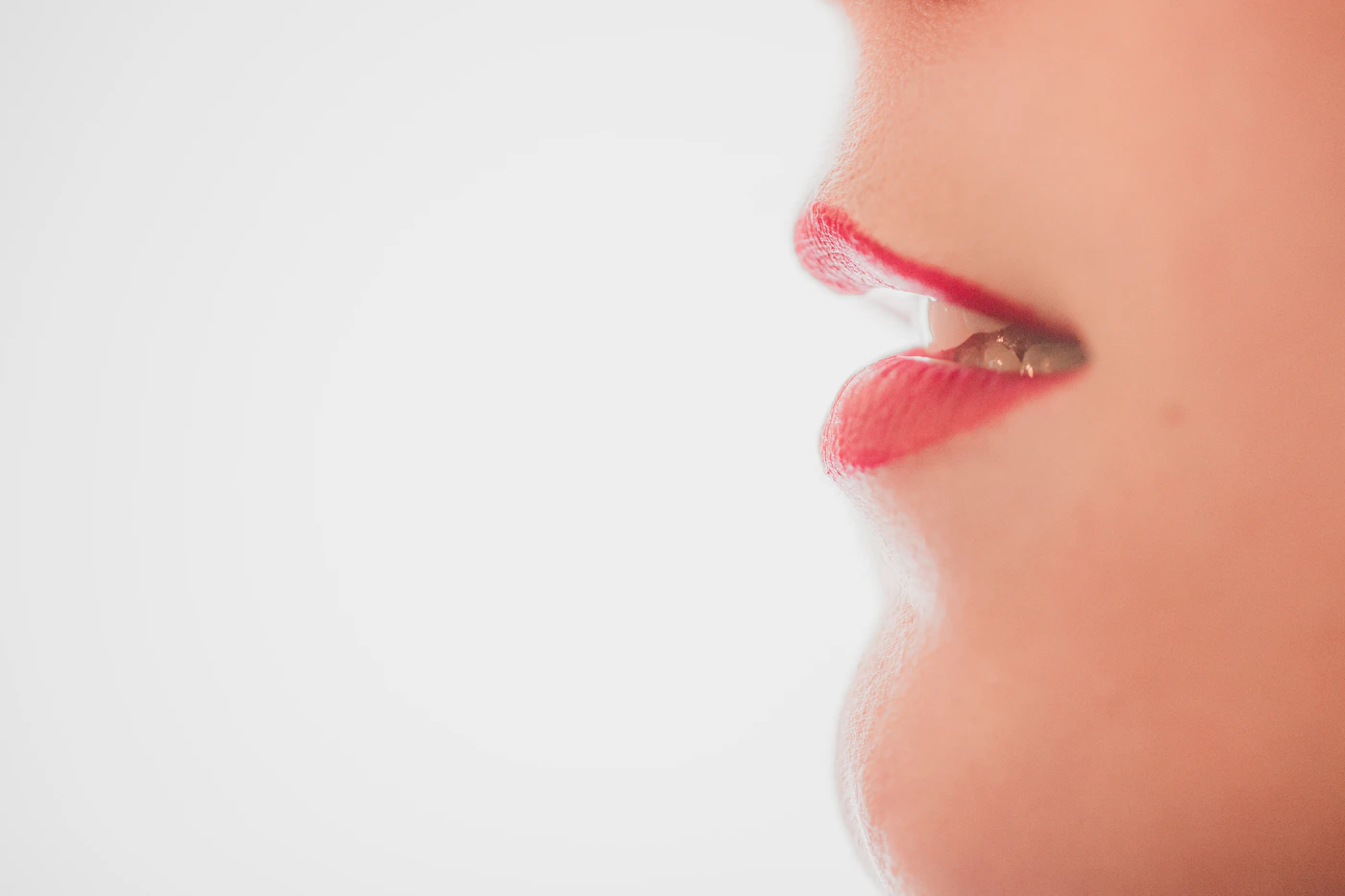Close-up portrait of a person's lips against a neutral background, clean editorial lighting clearly showing natural lip shape, vermilion border and cupid's bow, representing the treatment area for lip filler