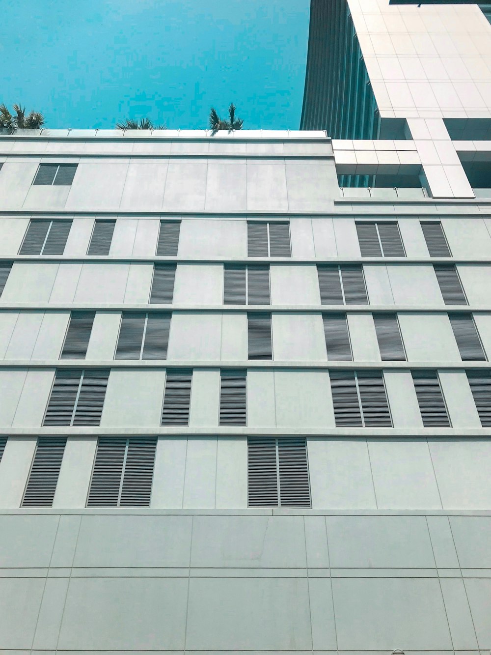low-angle photography of white high-rise building