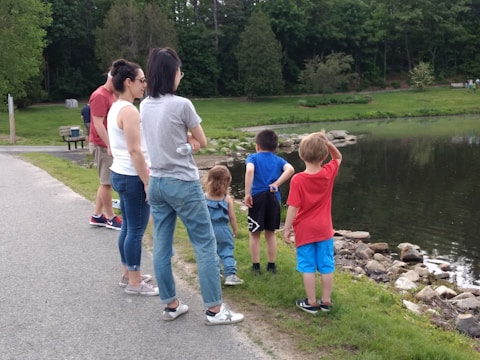 A group of students exploring a pond during a nature activity.