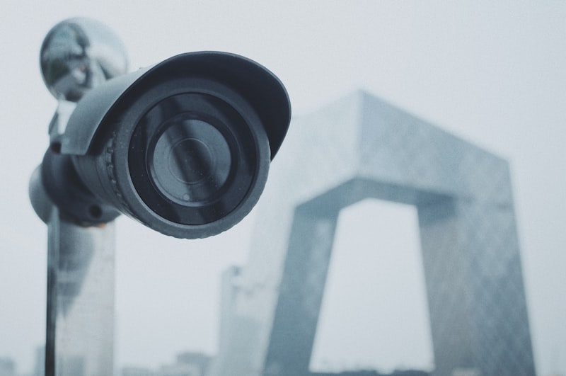 Black CCTV security camera mounted on a wall
