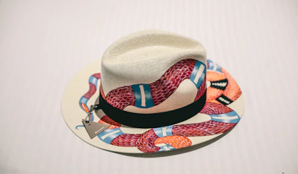 white and multicolored snake print fedora hat
