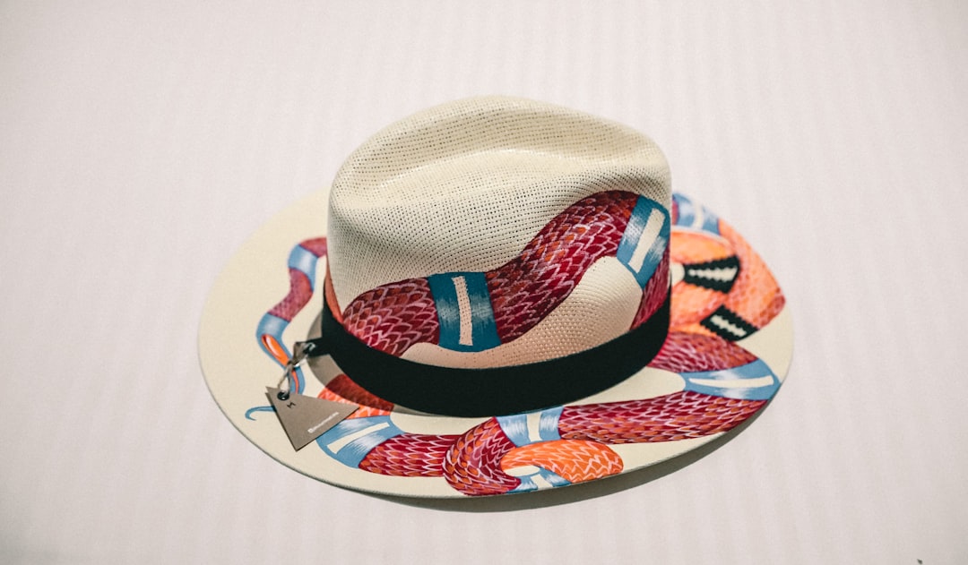 white and multicolored snake print fedora hat