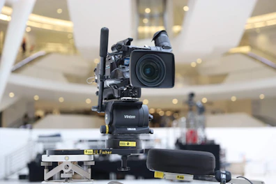 High-tech 4K PTZ camera mounted in a professional conference room.