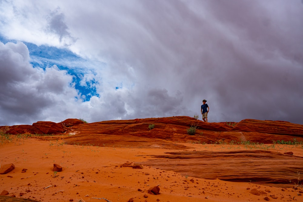 man standing on brown field